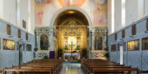 A church with pews and paintings on the walls