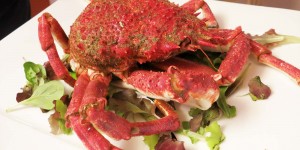 A plate of crab with lettuce on top.