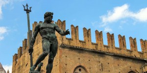 A statue of a man in front of an old building.