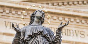 A statue of a woman with stars around her head.