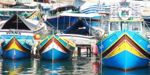 A group of boats in the water near each other.