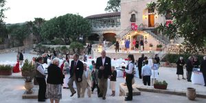 A group of people walking around in the courtyard.