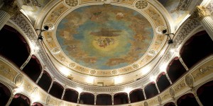 A ceiling with paintings on it and many steps