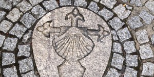 A stone carving of an anchor and shell.