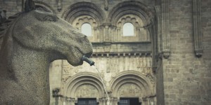 A statue of an elephant drinking water from a fountain.