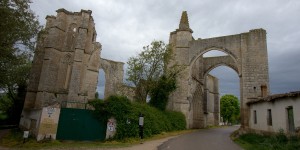 A large stone building with trees in the background.