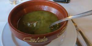 A bowl of soup is sitting on the counter.