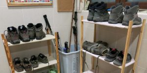 A room with several shelves and some shoes on it.