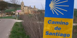 A sign in front of some buildings with trees