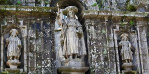 A statue of a woman holding a stick in her hand.