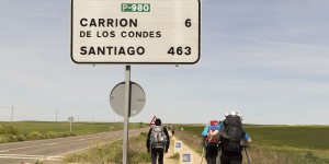 A group of people walking on the side of a road.