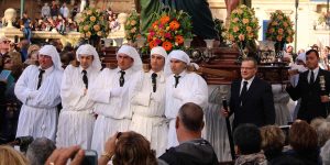 Maltese men dressed in white robes as part of the Easter ceremony..