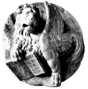 A lion statue with a book in its mouth.