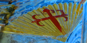 A close up of the red cross on a yellow fan