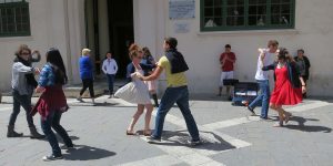 A couple of people that are dancing on the street