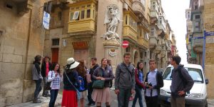 A group of people standing on the side walk
