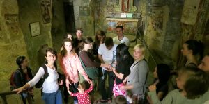 A group of people standing around in an old building.