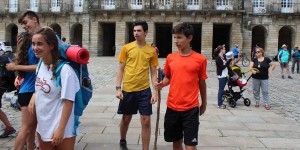 Two young men in yellow shirts and a red shirt