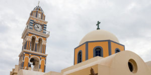 A church with a clock tower in the background.