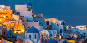 A view of the town of oia at dusk.