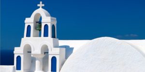 A white church with blue trim and a bell tower.