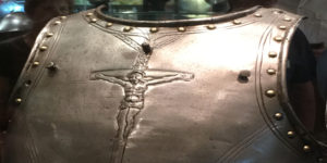 A metal crucifix with the image of jesus on it.