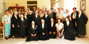 A group of people in black robes and white hats.