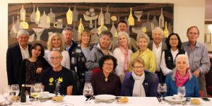A group of people posing for a picture at a table.