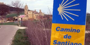 A sign in front of some buildings and trees
