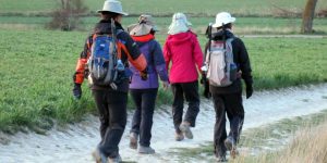 A group of people walking on the side of a road.