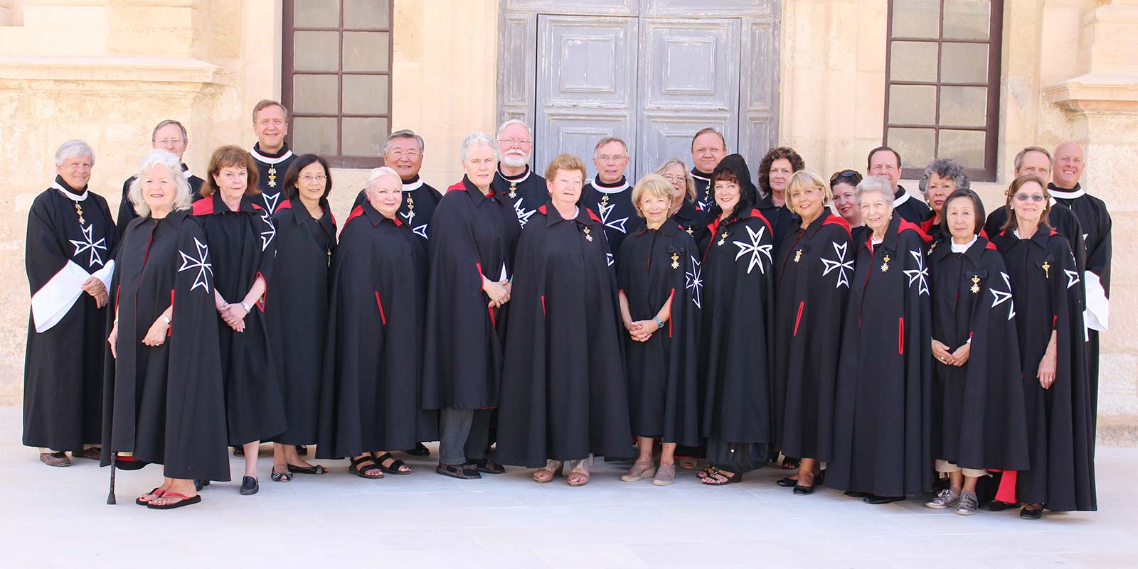 A group of people standing in front of a building.