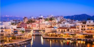 A picture of beautiful Crete in early evening, many buildings and water.