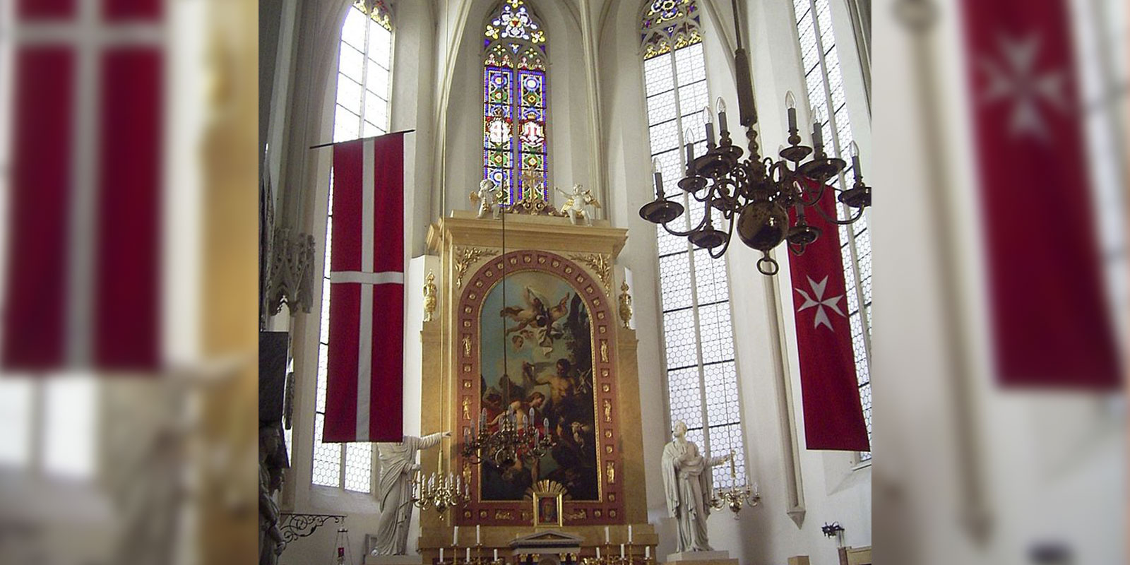 Order of Malta church in Vienna with Order flags and Icon of Mary over Altar.