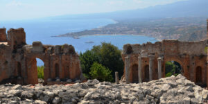 Beautiful Sicilian coastline on a sunny day with ruins in the foreground and the sea in the background.