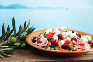 Beautiful Sicilian salad plate with olives, feta cheese, and onions.