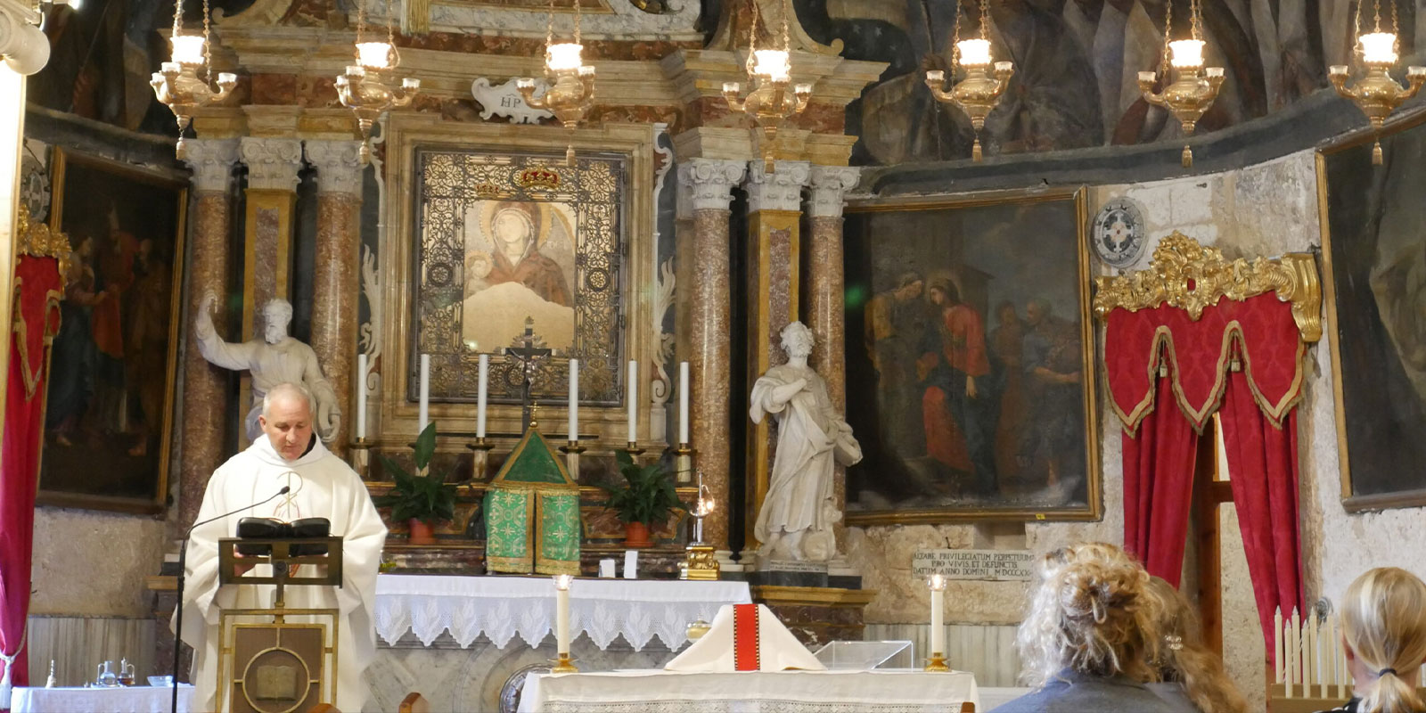 Priest offering Mass on a student pilgrimage to Malta for the MedSeas student group.